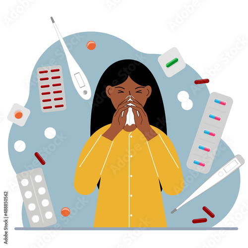A woman covers his nose with his hands with a handkerchief. The concept of a cold person, seasonal allergies. Lots of medicines and thermometers.