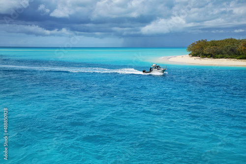 Boat going through the channel between Mouli and Ouvea Islands, Loyalty Islands, New Caledonia.