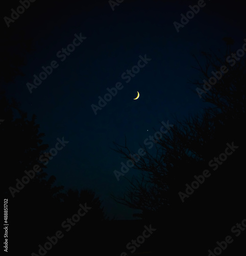 Fotografie A waning crescent moon in the night sky above Orwell, Ohio