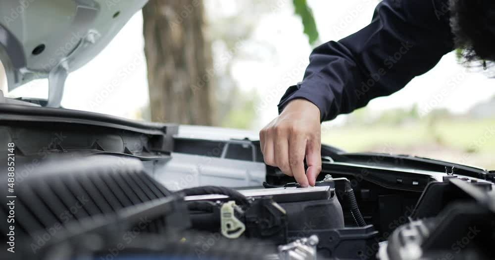 Asian Man mechanic inspection shine a torch car engine checking bug in engine. Service maintenance insurance with car engine. Car service concept.
