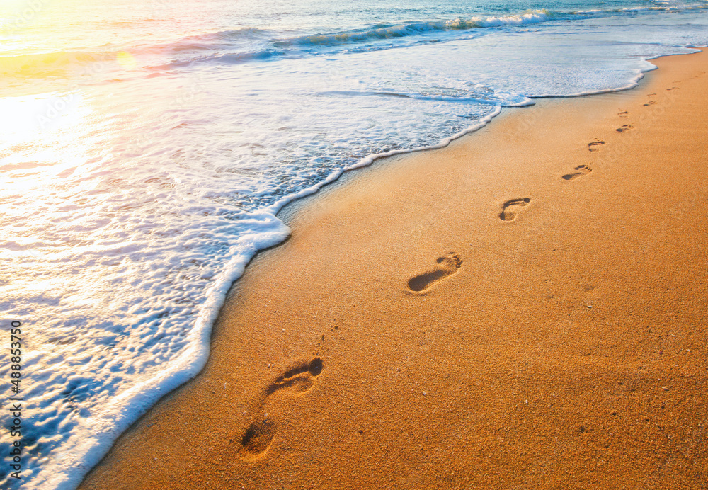 footprints on tropical beach and beautiful wave footprints on tropical beach and beautiful wave