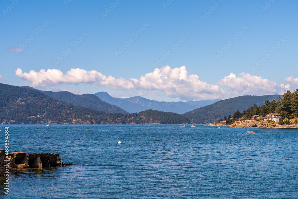 ocean view with mountains, blue sky and white clouds in slow motion at summer day in Vancouver, Canada