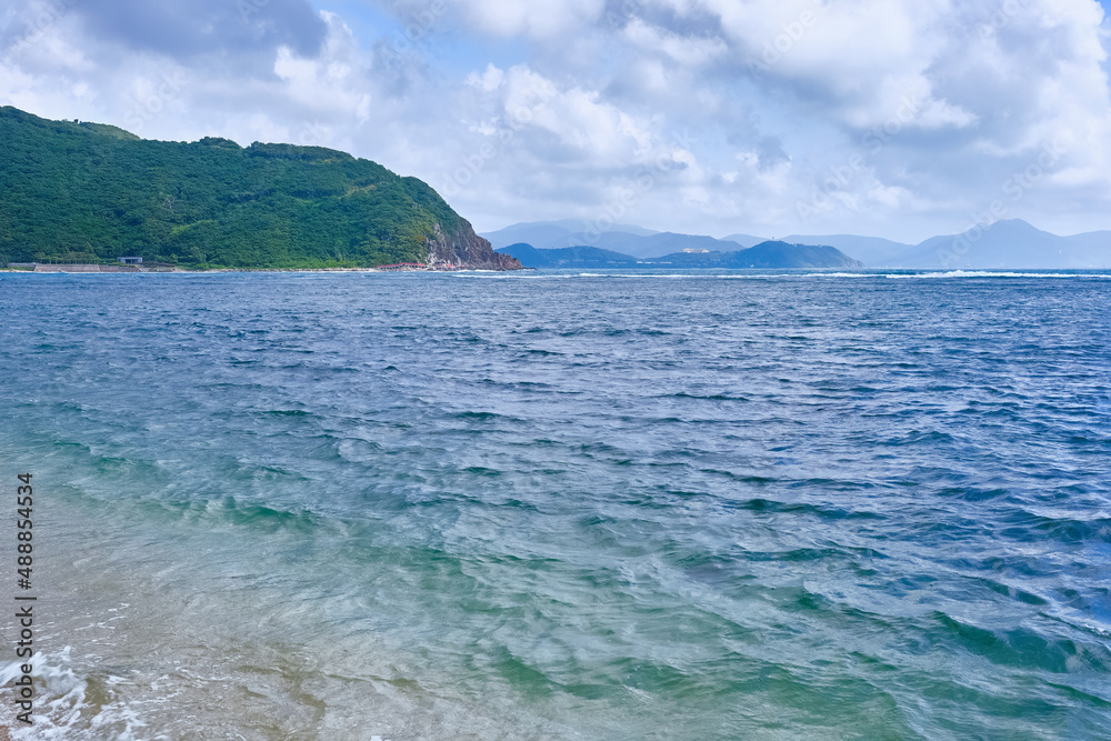 Fototapeta premium View from the beach to the mountains and Dadonghai Bay of Sanya, Hainan.