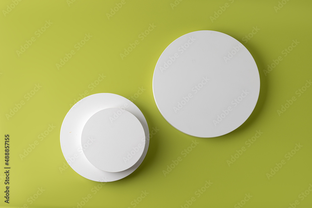 Podiums. White round podiums for presentation.  Pedestals top view on light gren background.