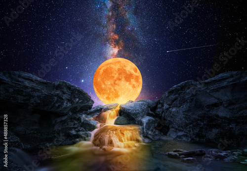 Colorful waterfall with big moon