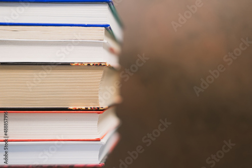 books of different color and size close-up with blurred background