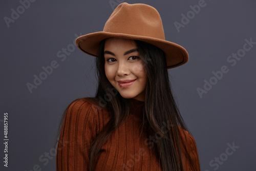 beautiful woman brown hat hand gestures brown sweater fashion emotions studio model