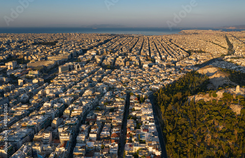 Fototapeta Naklejka Na Ścianę i Meble -  Sunrise, top view of the famous Athens, rectangular streets and a grid of buildings, quarters directed towards the sea, mountains on the horizon, Greece