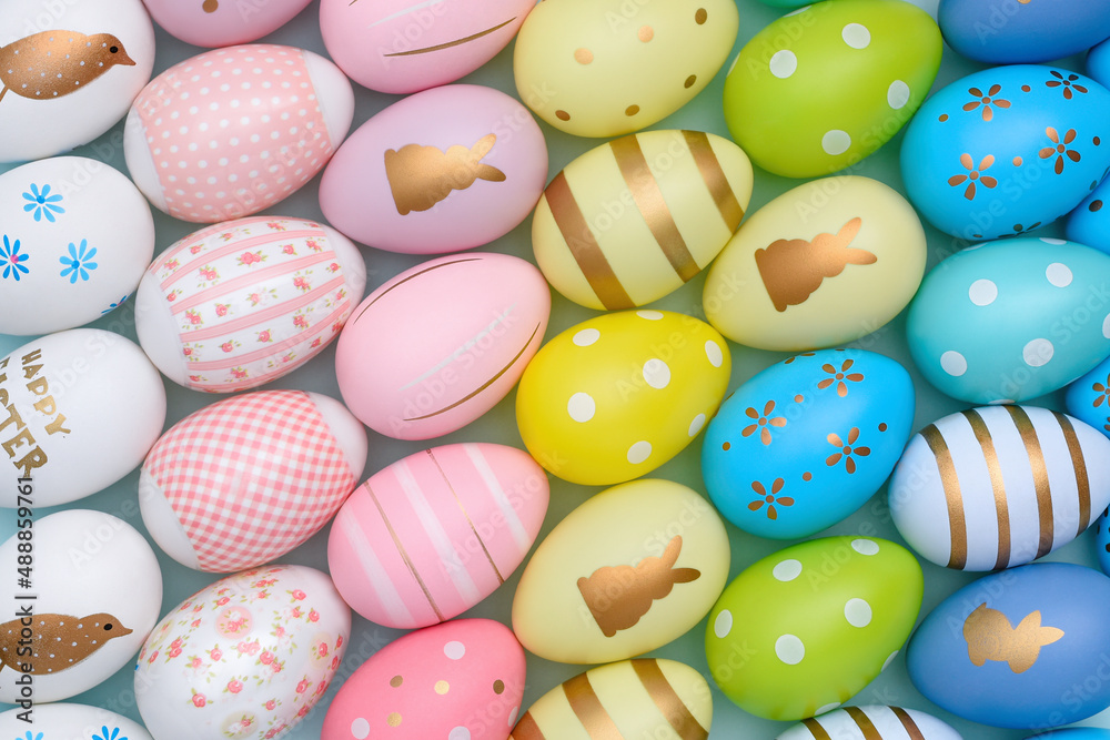 Colorful Easter eggs background. Many decorative painted Easter eggs are arranged in rows by color. Easter eggs Gradient.