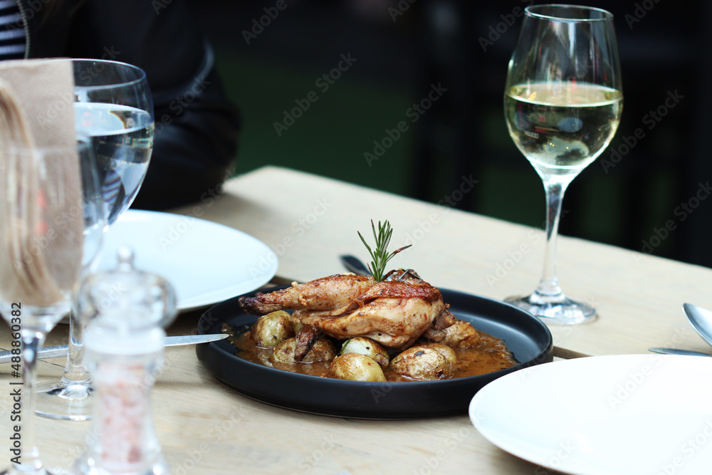 Roasted Chicken on black plate and wood table