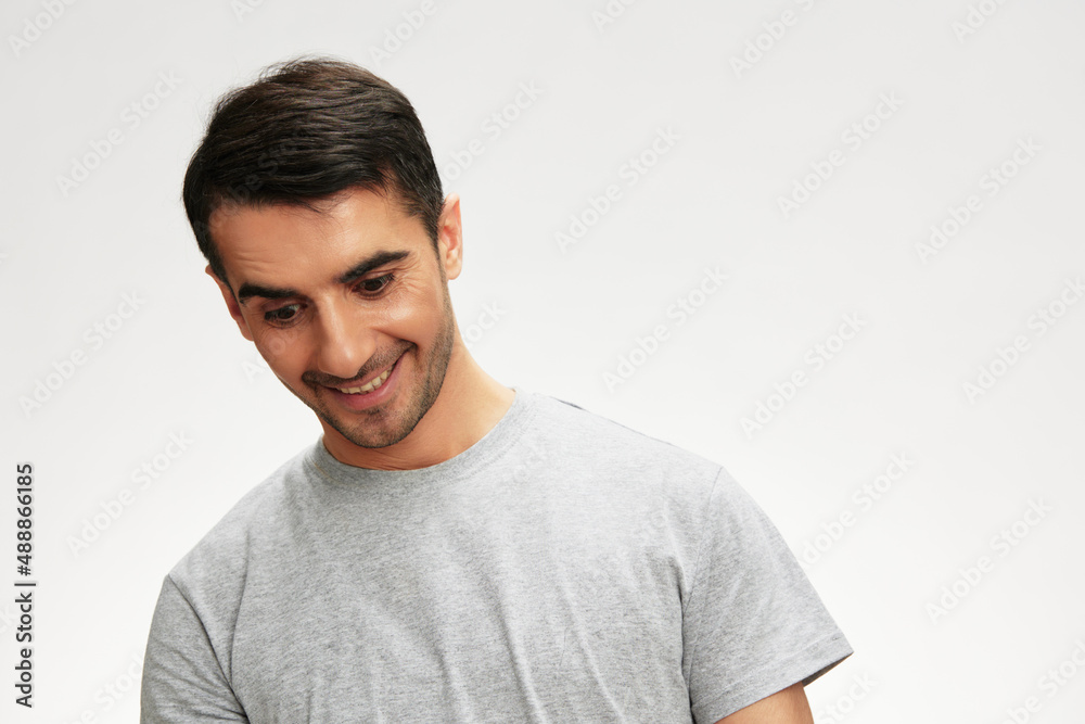 Cheerful man in gray t-shirts posing lifestyle casual wear isolated background Cheerful man in gray t-shirts posing lifestyle casual wear isolated background