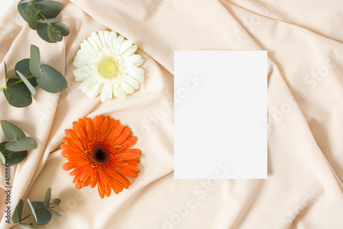 Wedding invitation mockup with gerbera and nude fabric