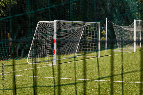 Green net and white football gates. Football theme. Selective focus.