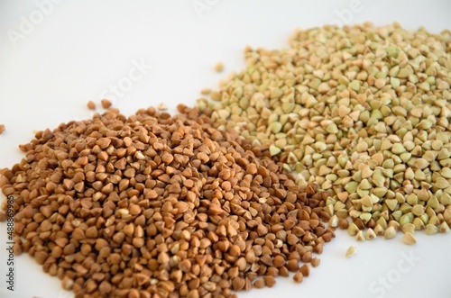 cereals of buckwheat and green unboiled buckwheat on a white background