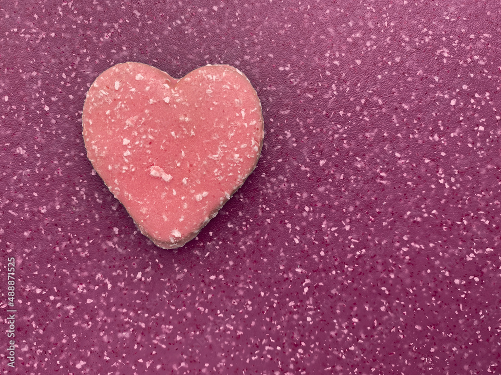 pink valentine shaped biscuit on magenta board