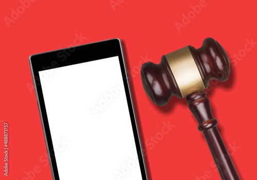 Blank screen seen on smartphone and judges gavel above it.