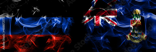 Donetsk People's Republic vs British, Britain, Cayman Islands flag. Smoke flags placed side by side isolated on black background.