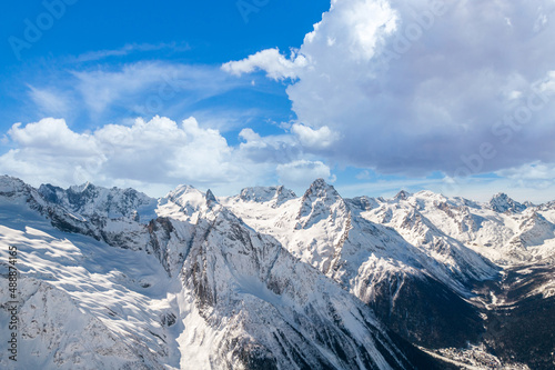 Fluffy cloud over mountains in winter 