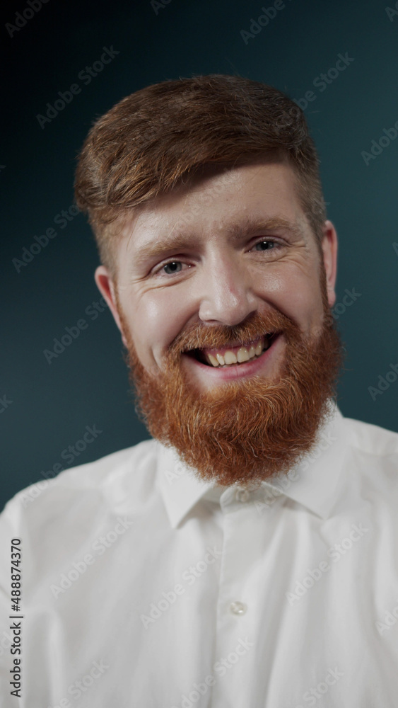 Portrait of a red bearded guy in white classic t-shirt making faces
