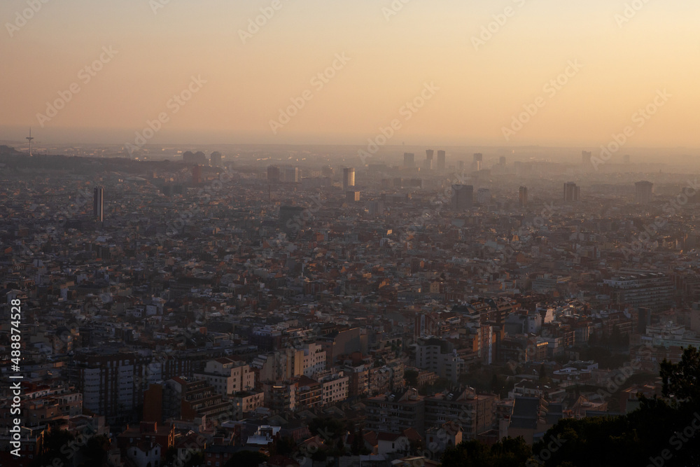 Big city during sunset. Silhouettes of buildings from above.