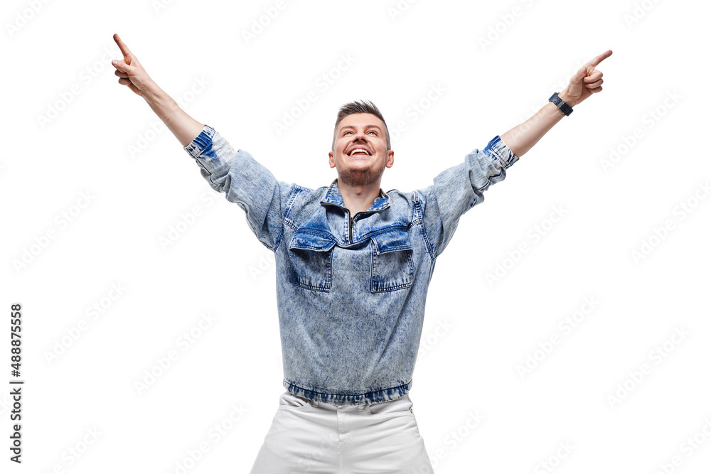 man in denim jacket celebrating success with hands up in the air man in denim jacket celebrating success with hands up in the air