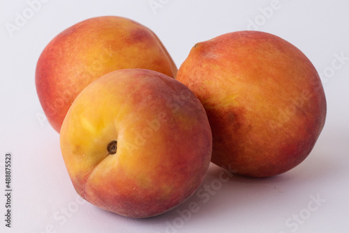 fresh peaches on a white meza photo