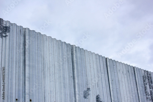 Metal fence close-up. Corrugated metal fence. Decking metal fence.