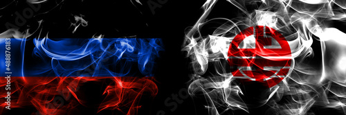 Donetsk People's Republic vs Japan, Japanese, Kaminokuni, Hokkaido, Hiyama, Subprefecture flag. Smoke flags placed side by side isolated on black background. photo