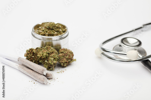 marijuana buds, grinder with joint,  phonendoscope, with white background.