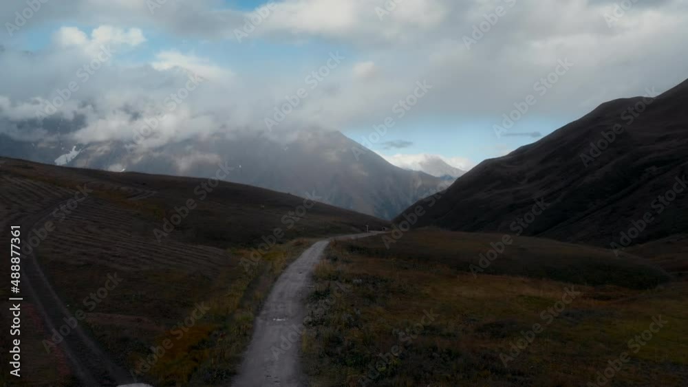 Two cyclists ride on high elevation mountain plato in Georgia. Bikepacking adventure in exotic destination. Cycle bike touring trend. Touring with bike bags and gear. Sustainable travel lifestyle Two cyclists ride on high elevation mountain plato in Georgia. Bikepacking adventure in exotic destination. Cycle bike touring trend. Touring with bike bags and gear. Sustainable travel lifestyle