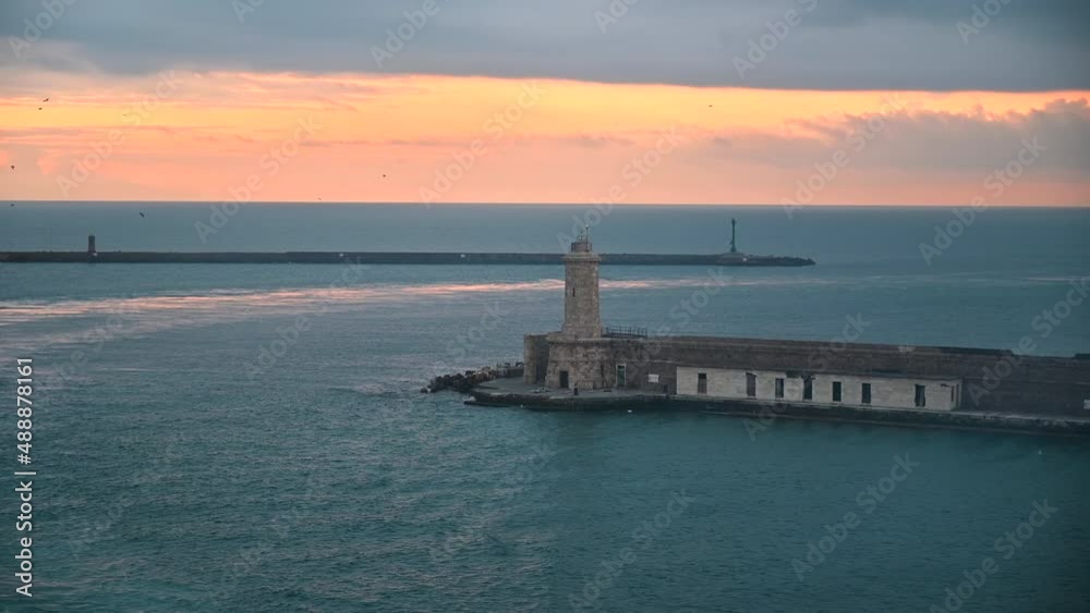 From ship view of beautiful lighthouse at sunset, entrance of the port of Livorno italy From ship view of beautiful lighthouse at sunset, entrance of the port of Livorno italy