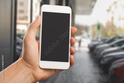 Hand with smartphone with empty blank screen