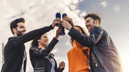 Canvas Print Lifestyle concept of young people raising hands with canned beers and having fun
