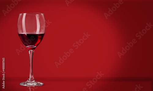 Red wine in the glass on the desk over red background
