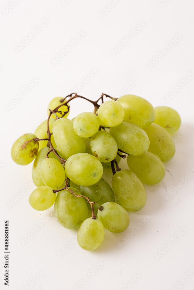 green grapes on white table, white background