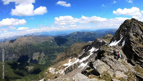 Woman walking on a hiking trail admiring the panoramic view from Reitereck in Carinthia, Maltatal in the Austrian Alps. Endless mountain chains in the High Tauern. Outdoor activity. Wanderlust
 photo