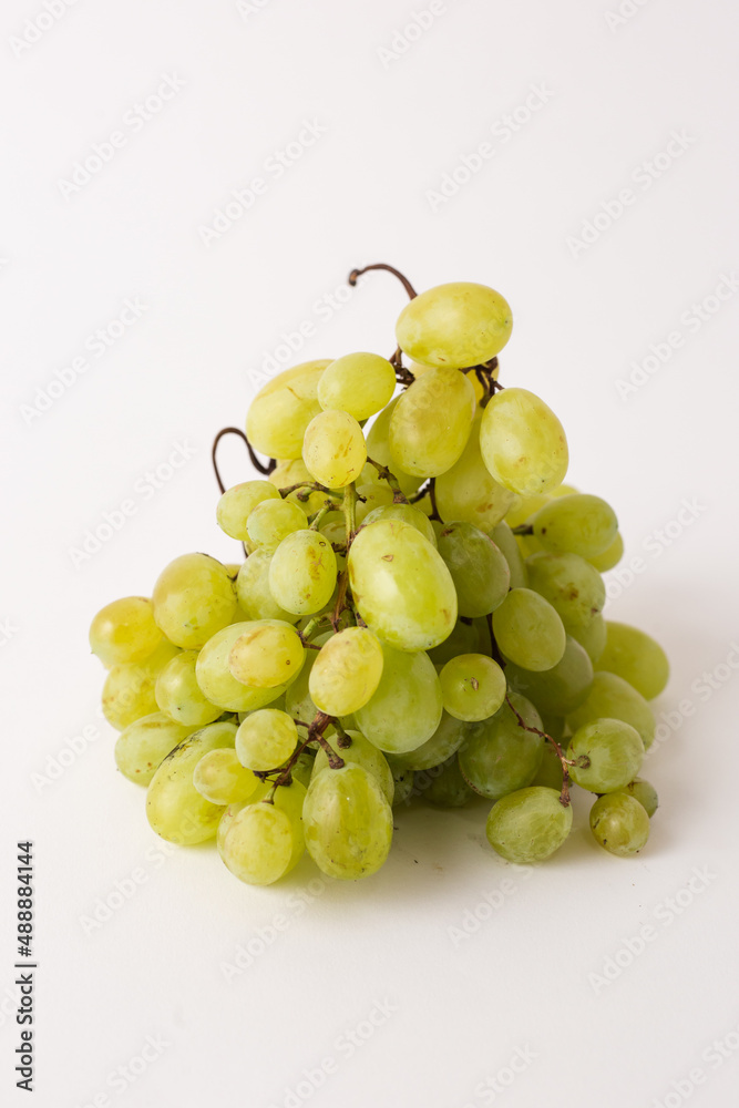 green grapes on white table, white background green grapes on white table, white background