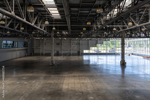 Spacious empty pavilion with windows for exhibitions and fairs. Hangar  a place intended for storage of large-sized objects. Modern large warehouse or storage