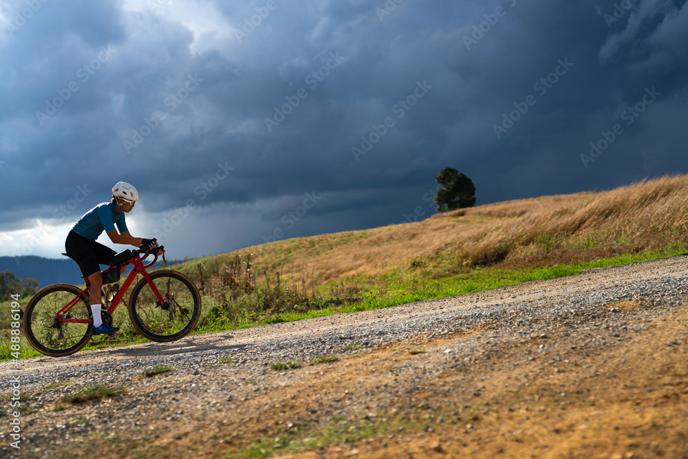 Cyclists practicing on gravel roads  in bad weather day