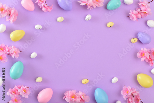 Background with Easter colored eggs on a purple background.