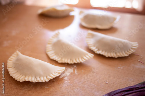 uncooked Argentine empanadas on a table