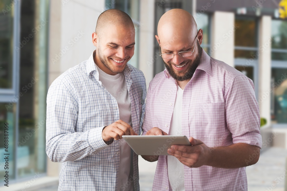 Portrait of successful business people working, in urban background.