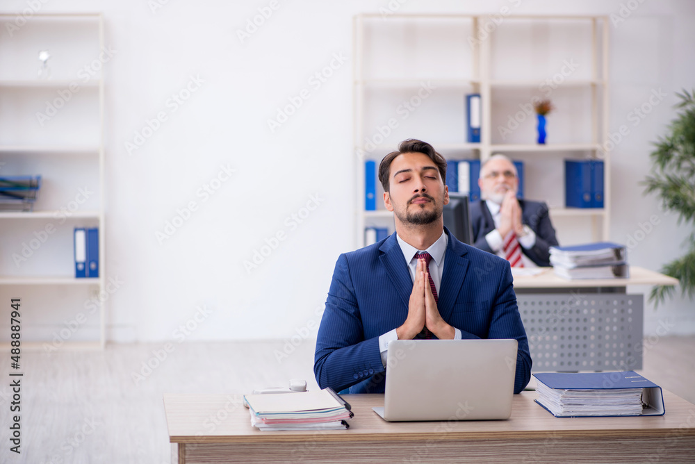 Two male colleagues working in the office Two male colleagues working in the office
