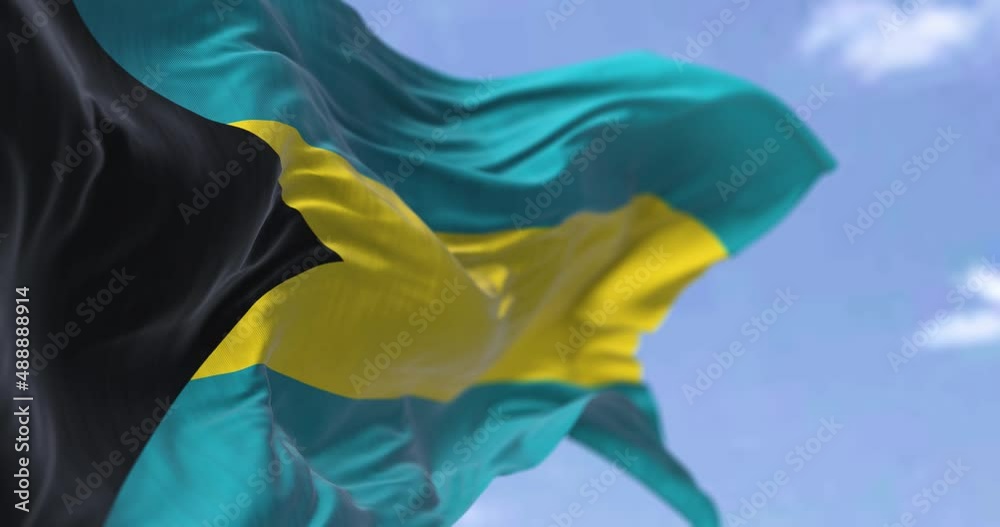 Detail of the national flag of Barbados waving in the wind on a clear day.