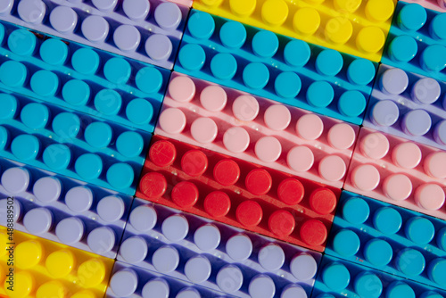 children s play background  the plane of plastic multi-colored bricks  blur  selective focus