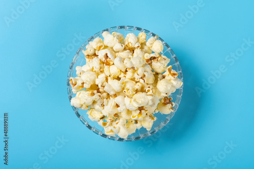 top view bowl of popcorn on a blue background