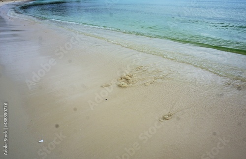 Fototapeta Naklejka Na Ścianę i Meble -  Empty beach with footprints