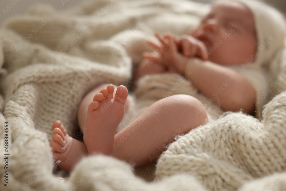Adorable newborn baby sleeping at home, focus on legs Adorable newborn baby sleeping at home, focus on legs
