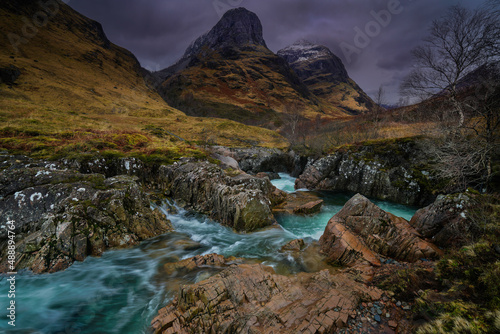 The River Coe Rapids with the backdrop mountain view of the three sisters, Glencoe, Highlands Scotland. © cliff