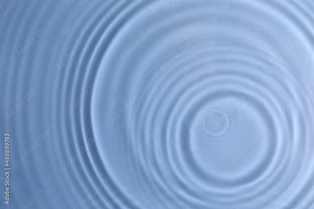 Closeup view of water with circles on blue background Closeup view of water with circles on blue background